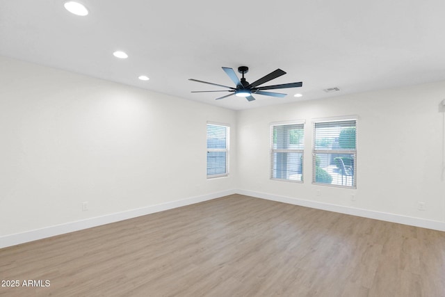 spare room with a ceiling fan, light wood-style flooring, baseboards, visible vents, and recessed lighting