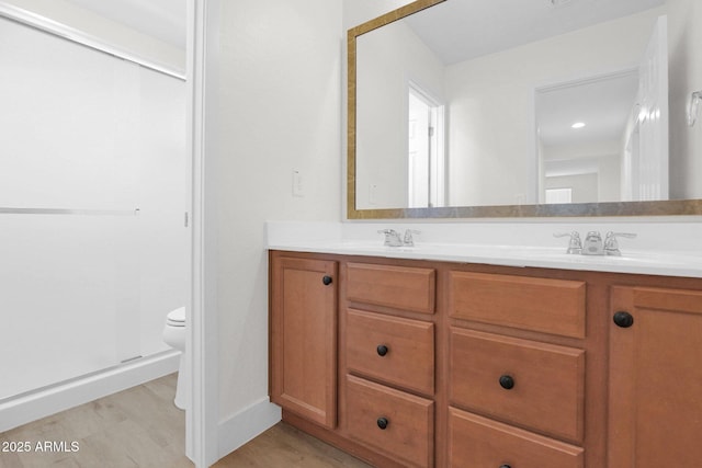 full bath featuring a sink, double vanity, and toilet