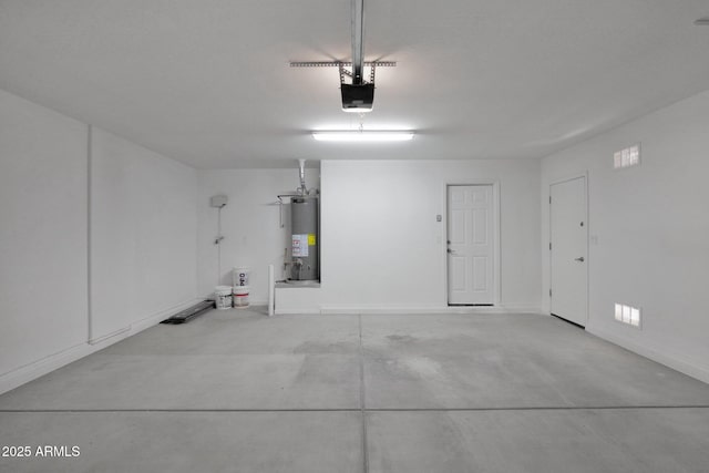 garage with a garage door opener, gas water heater, and baseboards
