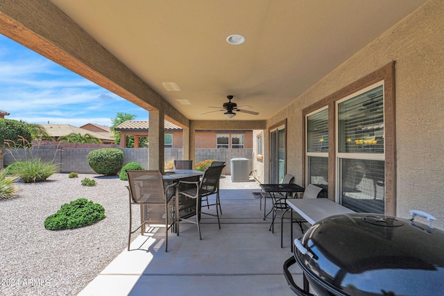 view of patio featuring central AC unit, a fenced backyard, outdoor dining area, and ceiling fan