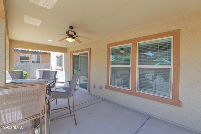 view of patio / terrace with outdoor dining space, ceiling fan, and fence