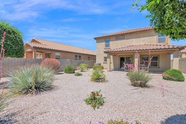 back of property featuring fence, a patio, a tiled roof, and stucco siding