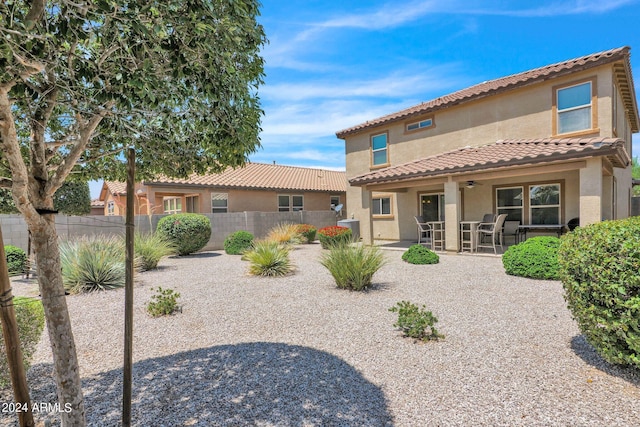 back of property featuring a tiled roof, fence, a ceiling fan, a patio, and stucco siding