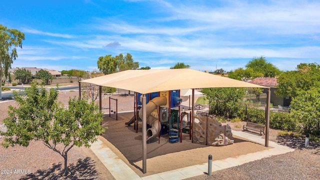 view of patio / terrace featuring a playground and fence