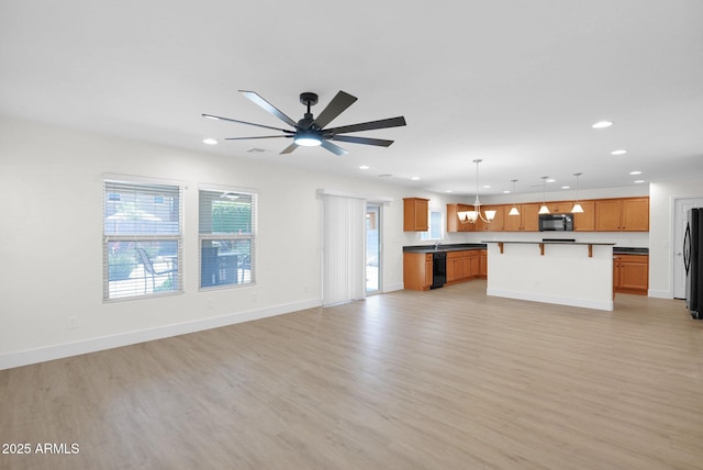 unfurnished living room featuring a ceiling fan, light wood-style floors, and recessed lighting