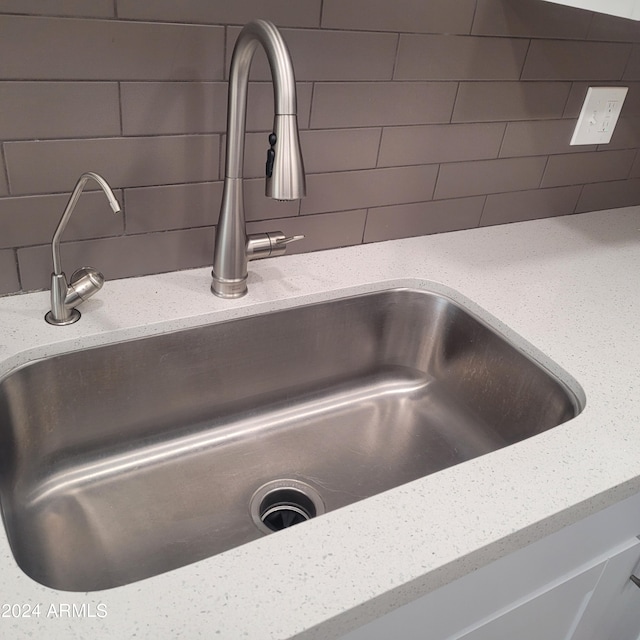 room details featuring sink and light stone countertops