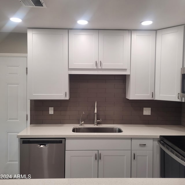 kitchen with dishwasher, white cabinetry, sink, electric range, and backsplash