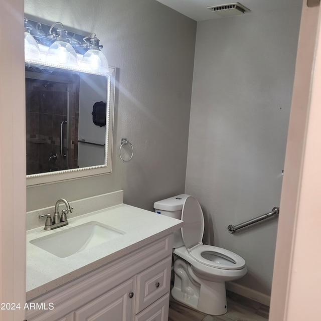 bathroom with toilet and vanity