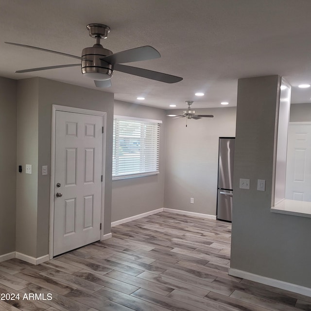 entryway with ceiling fan and light hardwood / wood-style flooring