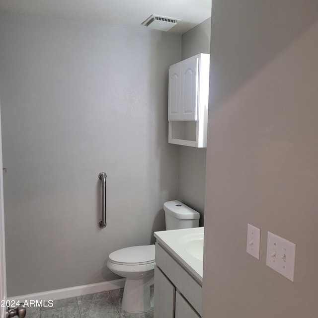 bathroom featuring vanity, toilet, and tile patterned floors