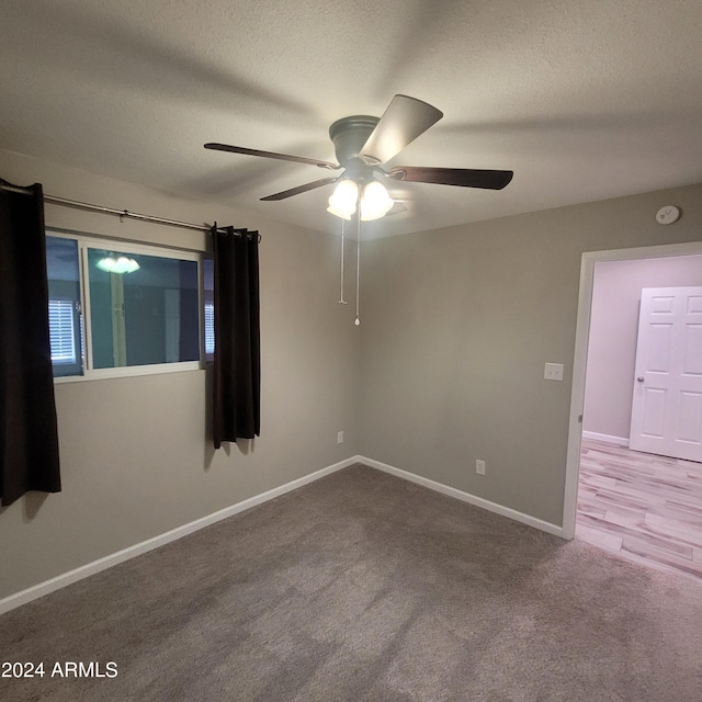 unfurnished room featuring ceiling fan, carpet, and a textured ceiling