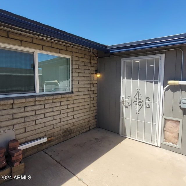 property entrance featuring a patio area