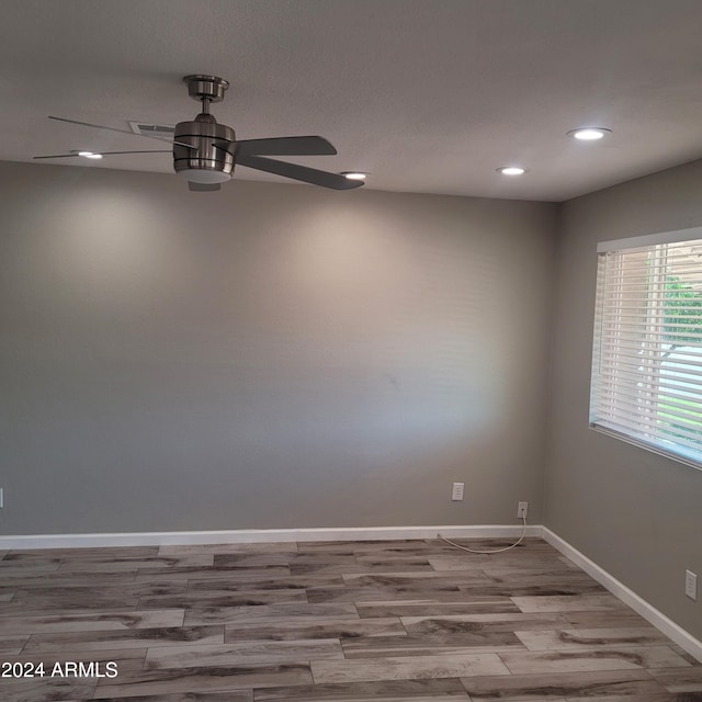 spare room with wood-type flooring and ceiling fan