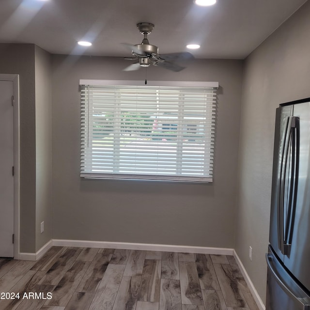 unfurnished dining area with ceiling fan and hardwood / wood-style floors