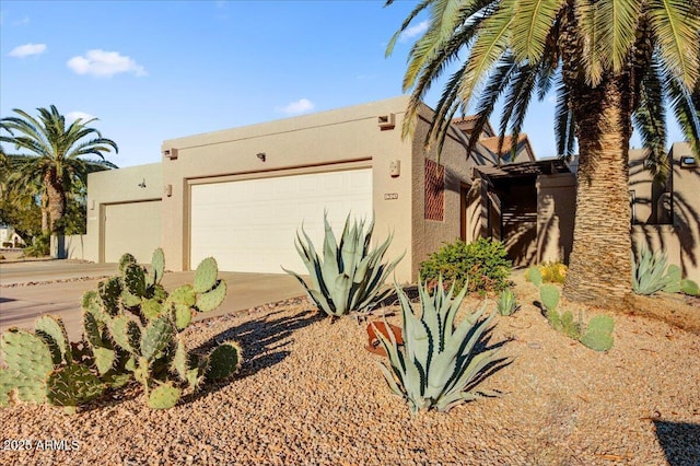 pueblo-style home with a garage