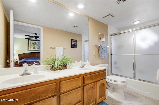 full bathroom with a textured ceiling, enclosed tub / shower combo, tile patterned floors, vanity, and toilet