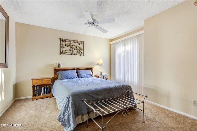 bedroom with light carpet, ceiling fan, and a textured ceiling