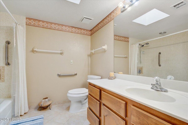 full bathroom with toilet, vanity, tile patterned floors, a skylight, and shower / bath combo with shower curtain