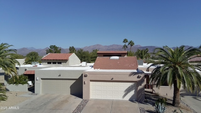 view of front of property featuring a mountain view and a garage