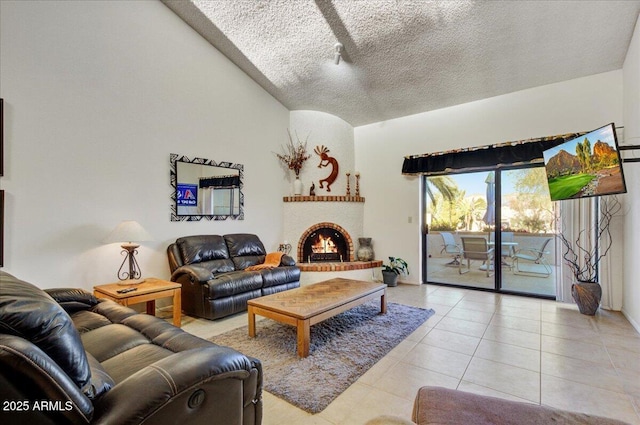 tiled living room featuring a textured ceiling and a fireplace