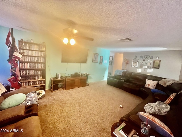 carpeted living room with a textured ceiling and ceiling fan