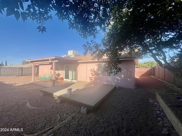 rear view of property with a wooden deck