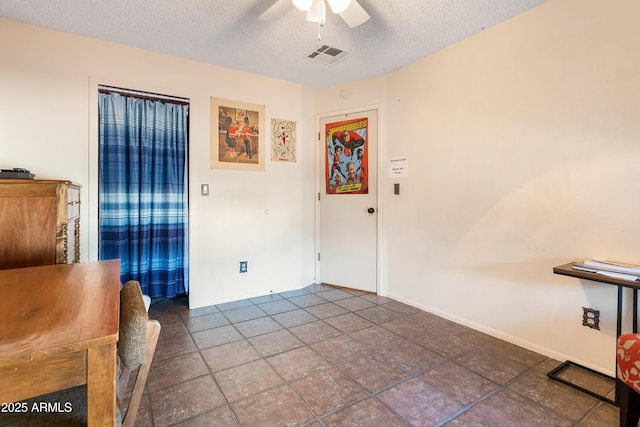 spare room featuring a textured ceiling and ceiling fan