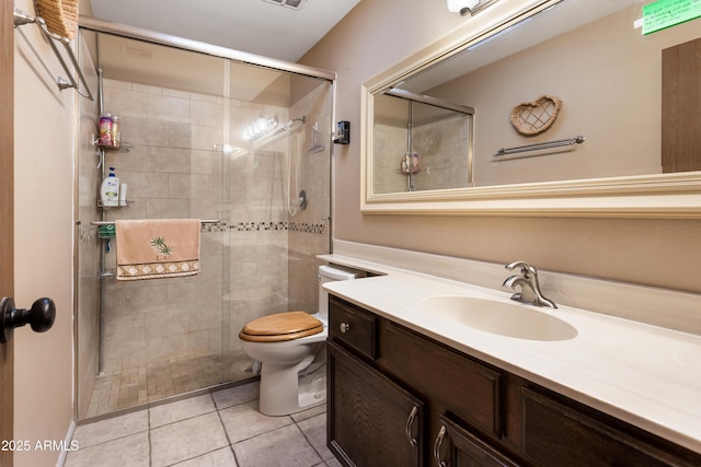 bathroom with tile patterned flooring, vanity, toilet, and walk in shower