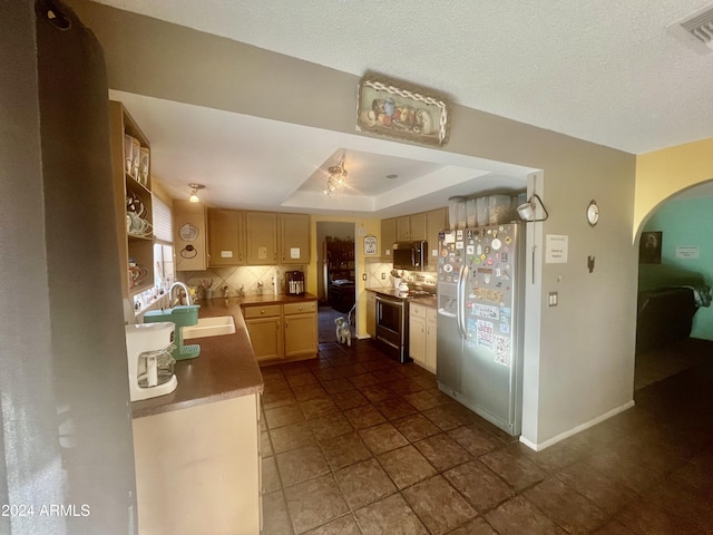 kitchen with sink, light brown cabinets, a raised ceiling, tasteful backsplash, and appliances with stainless steel finishes