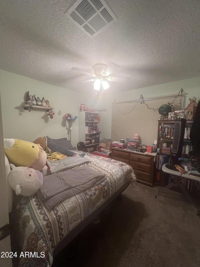 carpeted bedroom featuring a textured ceiling and ceiling fan