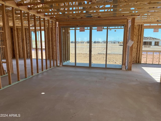 miscellaneous room with a rural view and concrete flooring