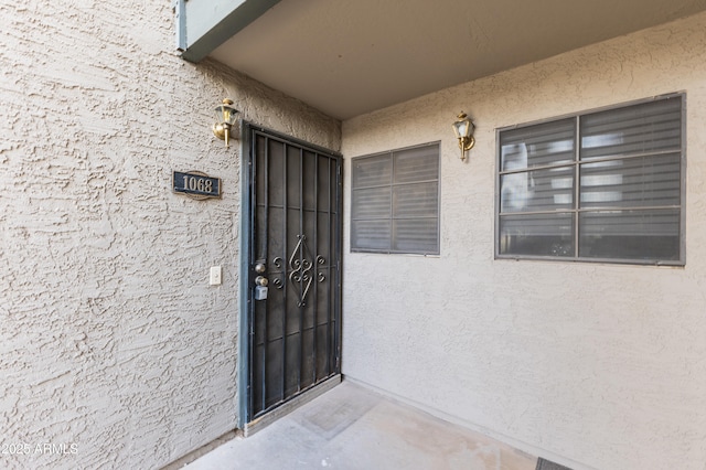 doorway to property with stucco siding