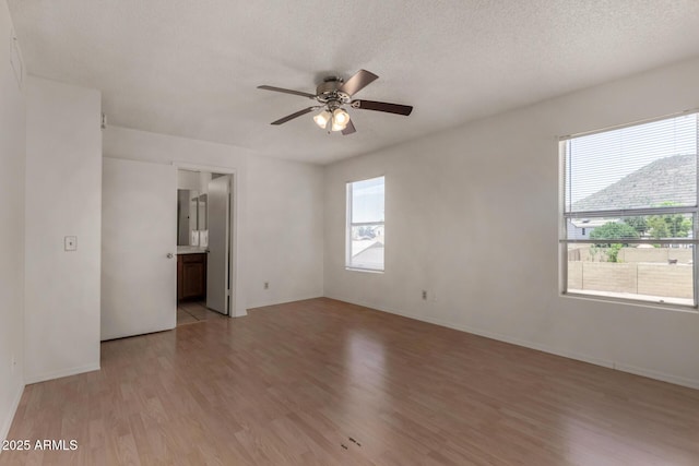 4644 W Havasupai Dr, Glendale, AZ 85308 - empty room featuring light wood-style flooring, ceiling fan, and a textured ceiling