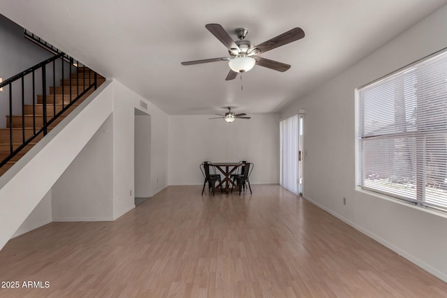 4644 W Havasupai Dr, Glendale, AZ 85308 - unfurnished living room with wood finished floors, stairs, and ceiling fan