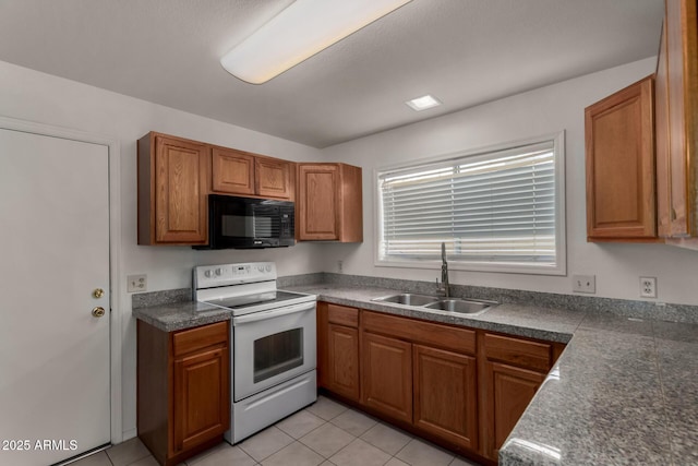 4644 W Havasupai Dr, Glendale, AZ 85308 - kitchen with white range with electric cooktop, black microwave, brown cabinets, and light tile patterned flooring
