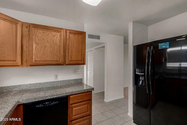 4644 W Havasupai Dr, Glendale, AZ 85308 - kitchen with black appliances, tile counters, light tile patterned flooring, and brown cabinetry