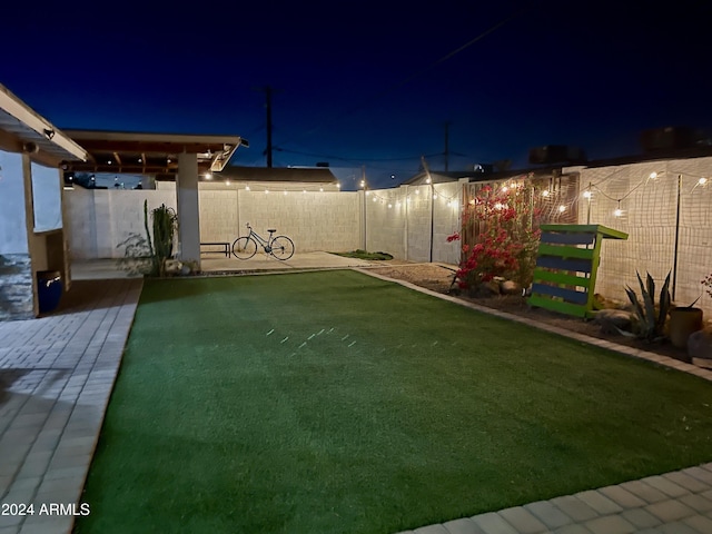 view of yard at twilight