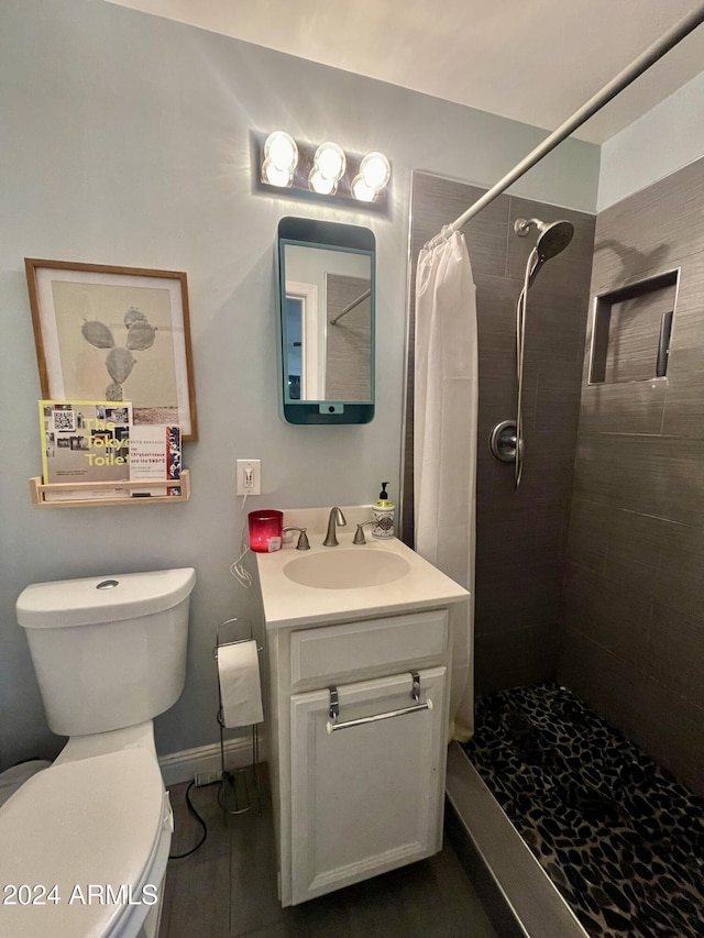 bathroom with vanity, toilet, and walk in shower