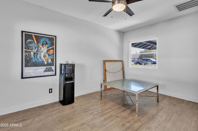 home office with ceiling fan and light hardwood / wood-style flooring