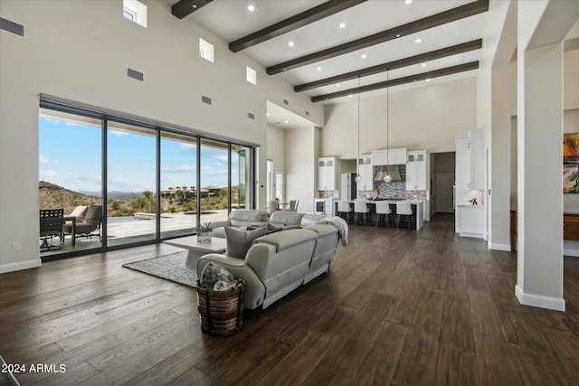 living room with dark hardwood / wood-style floors and beamed ceiling