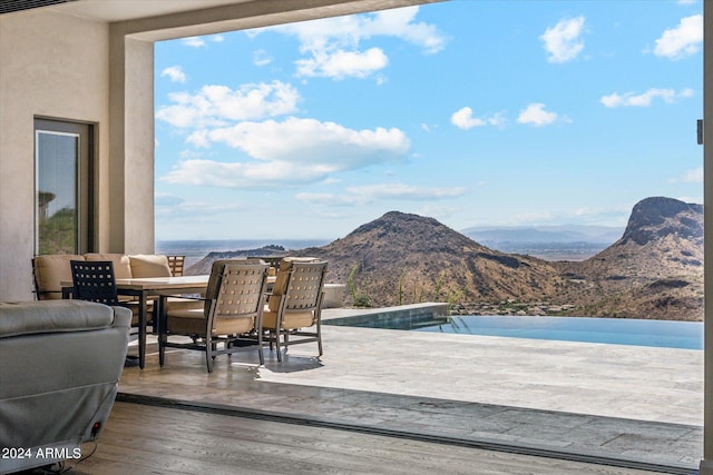 view of swimming pool with a mountain view and a patio area