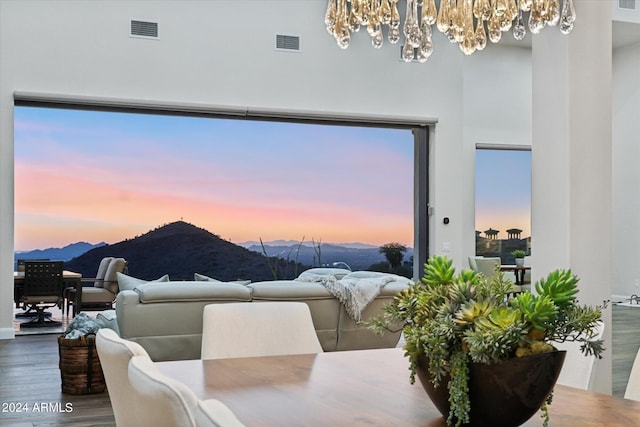 dining area with a chandelier, a mountain view, and hardwood / wood-style floors