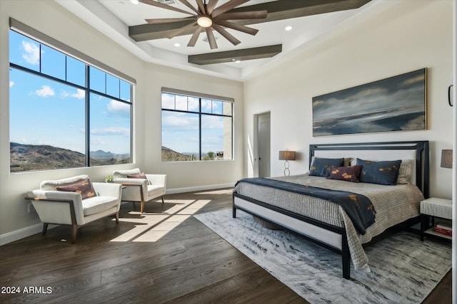 bedroom featuring a high ceiling, a mountain view, dark hardwood / wood-style floors, and ceiling fan