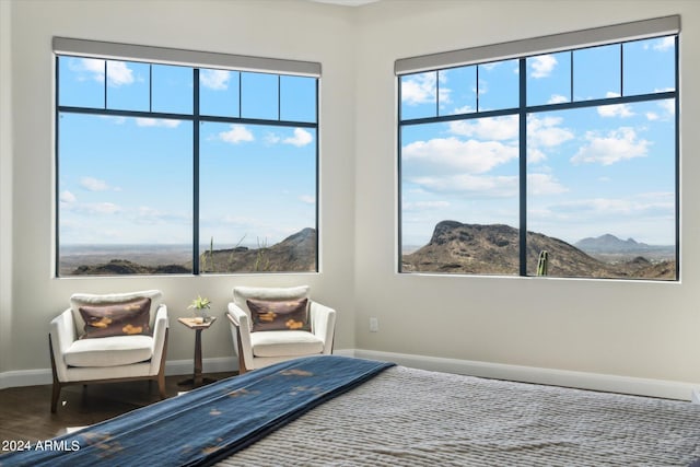 bedroom featuring a mountain view and hardwood / wood-style floors