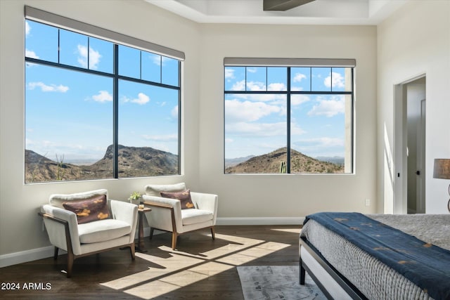 bedroom with dark hardwood / wood-style floors and a mountain view