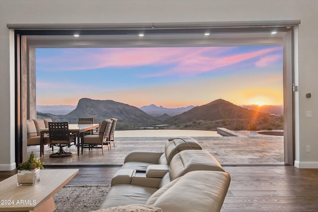 living room featuring a mountain view and hardwood / wood-style floors