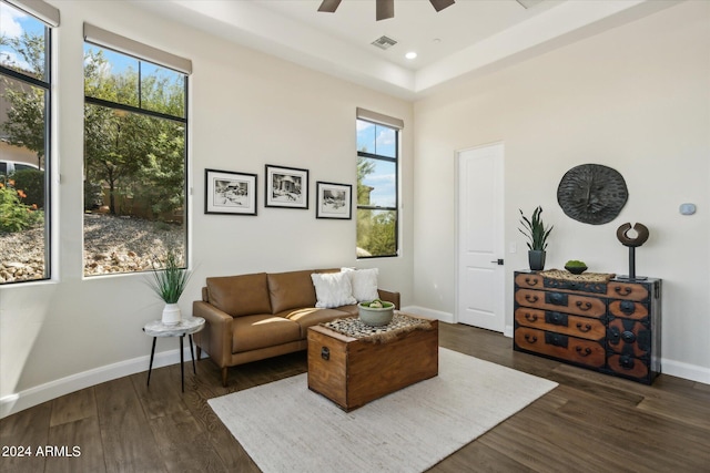 living room featuring ceiling fan and dark hardwood / wood-style flooring