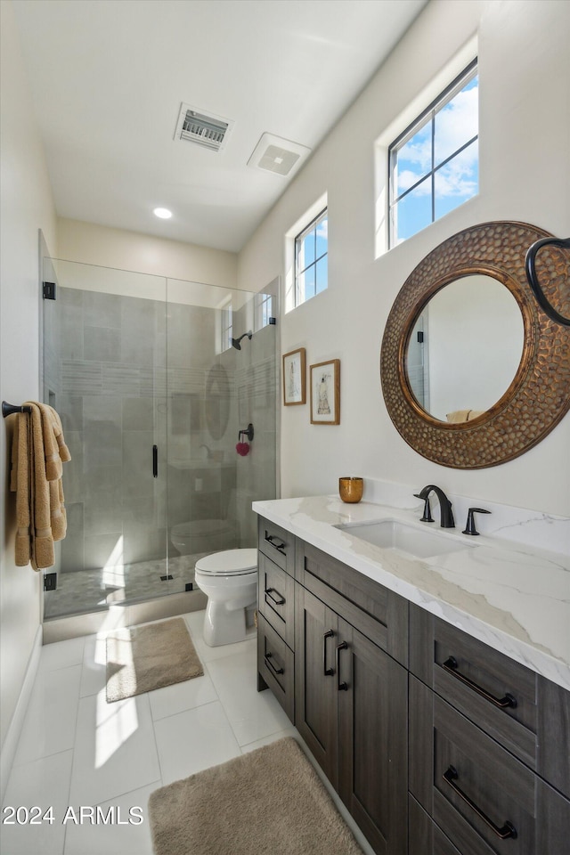 bathroom with vanity, an enclosed shower, tile patterned floors, and toilet