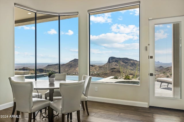 dining space with a mountain view and dark hardwood / wood-style floors