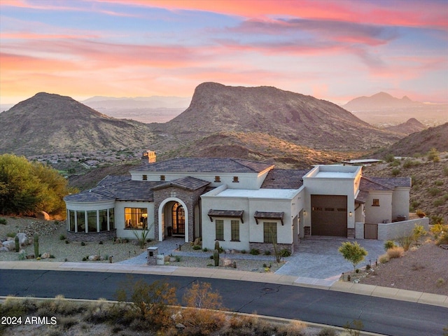 view of front facade with a mountain view and a garage